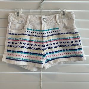 The brand is Gymboree. A size 10. White jean shorts.